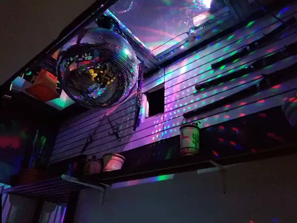 View of a huge disco ball in a skylight of a Body Piercing Studio in downtown Montreal offering ear piercing services.